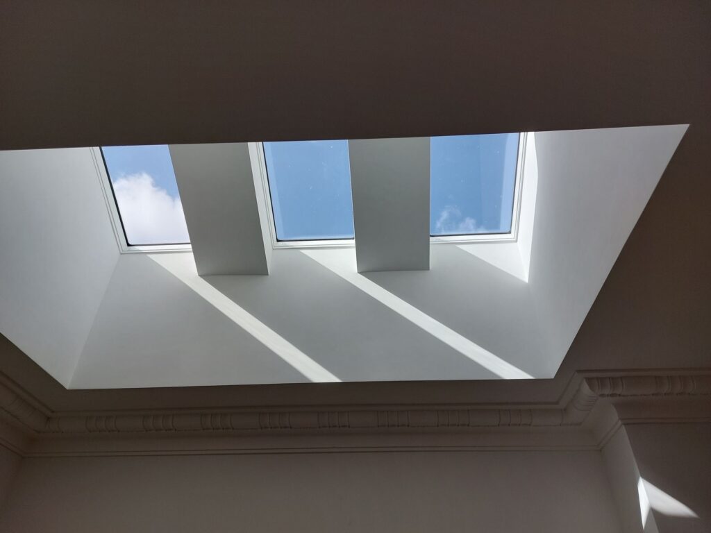 The skylights prior to the installation of the  external shading. While skylights are a great source of natural daylight, they can cause a building to overheat when the sun is almost directly overhead in summer.